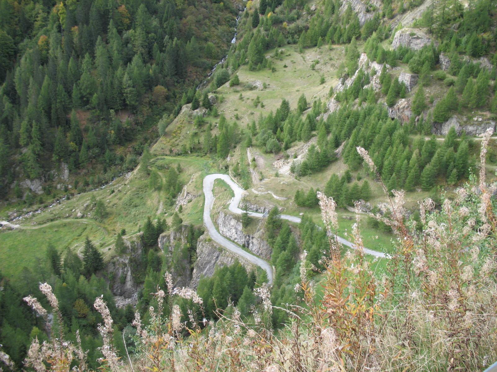 Der Stausee del Sambuco, ein Ort von tiefer Ruhe und erhabener Pracht. Das türkisfarbene Wasser spiegelt die umliegenden Gipfel wider und scheint einen Zugang zu einer verborgenen Welt zu bieten. Das Bild zeigt die enge Straase